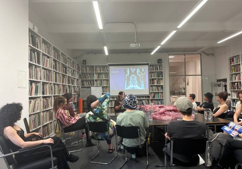 Frances Breden presenting in a room full of people.