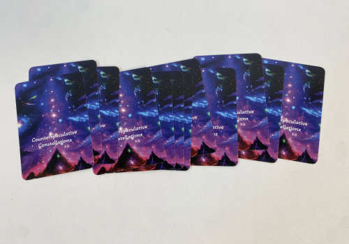 A row of cards face down with an AI-generated image of stars and mountains on them.
